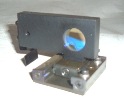 Single axis laser optic position and optic mount