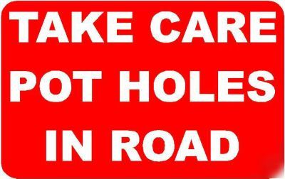 Take care pot holes in road sign/notice
